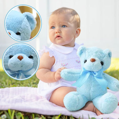 bébé assis avec ours en peluche